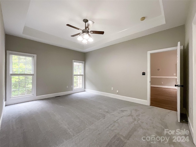 2510 Doster Rd, Monroe, NC 28112 - carpeted spare room with baseboards, a ceiling fan, and a raised ceiling