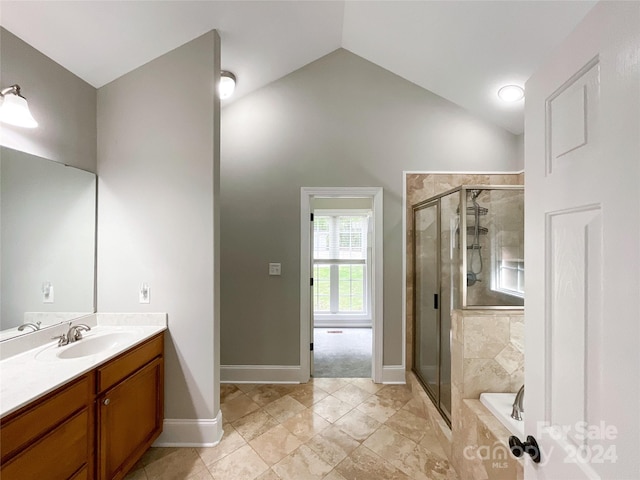 bathroom featuring tile patterned flooring, vanity, vaulted ceiling, and separate shower and tub