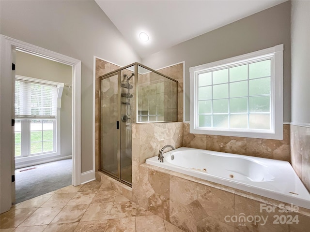 bathroom featuring vaulted ceiling and independent shower and bath