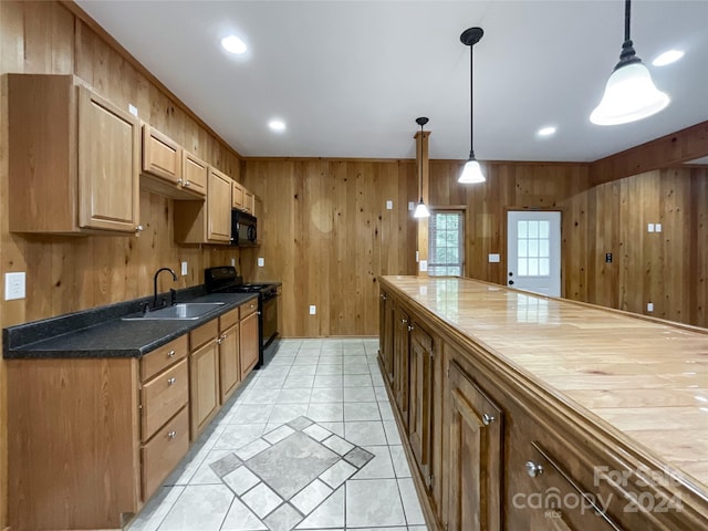 2510 Doster Rd, Monroe, NC 28112 - kitchen with wood walls, recessed lighting, light tile patterned floors, a sink, and black appliances