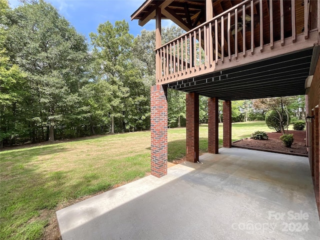 view of yard featuring a patio area and a wooden deck