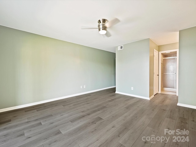 spare room featuring ceiling fan and hardwood / wood-style flooring