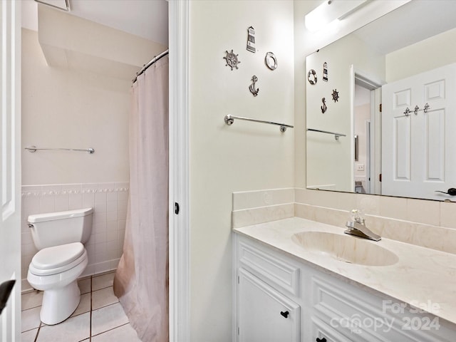 bathroom featuring tile walls, tile patterned flooring, vanity, and toilet