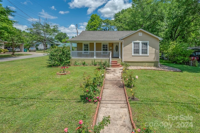 view of front of house featuring a front yard and covered porch