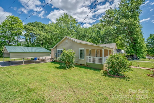 rear view of house with a yard, a porch, and a carport