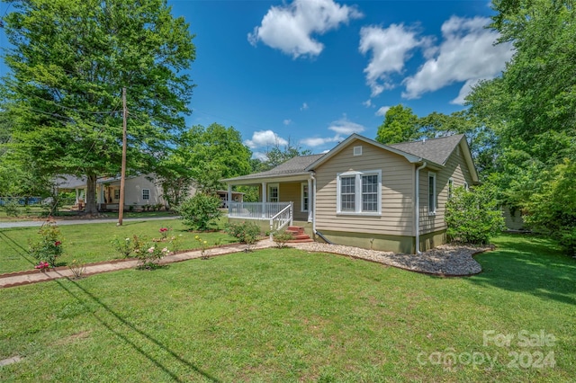 single story home with covered porch and a front lawn