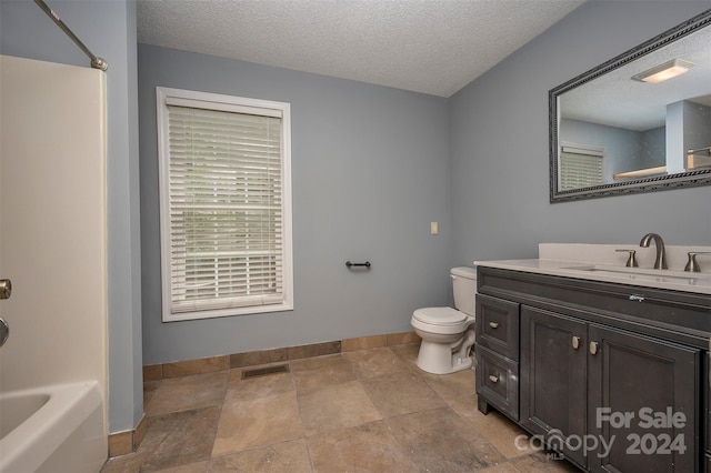 full bathroom featuring vanity, toilet, bathtub / shower combination, and a textured ceiling