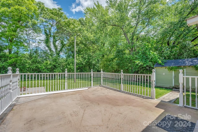 view of patio with a storage shed