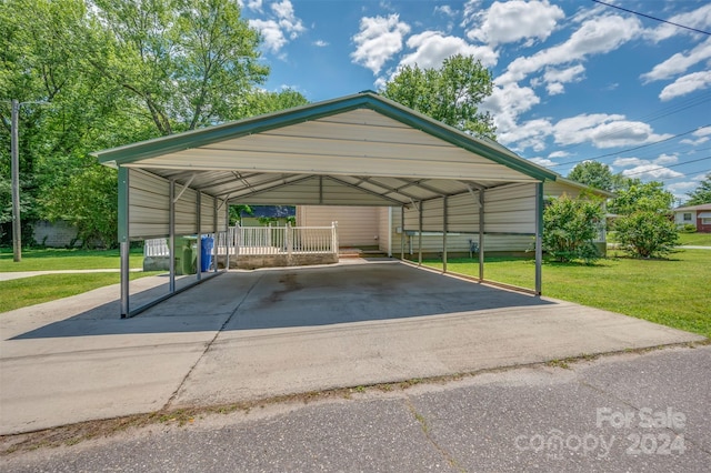 view of parking / parking lot with a yard and a carport