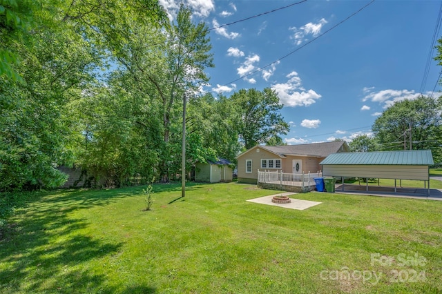 view of yard with a shed and a carport