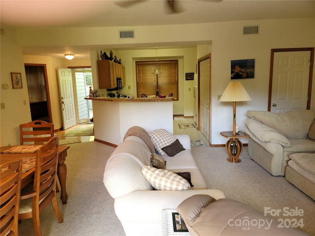 living room featuring light colored carpet and ceiling fan