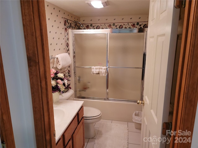 full bathroom with vanity, toilet, tile patterned floors, and enclosed tub / shower combo