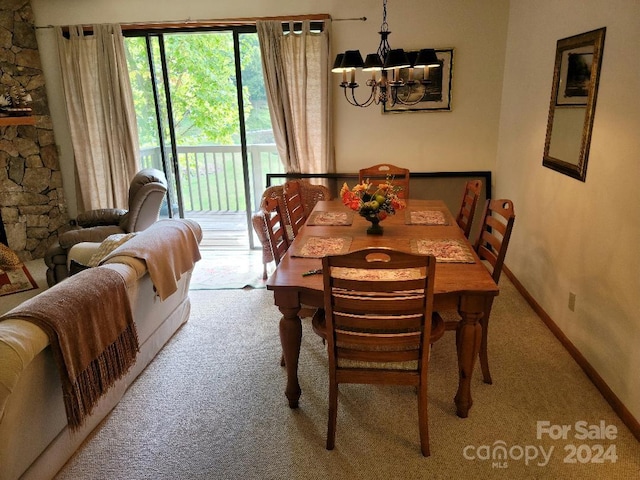 dining room featuring a chandelier and carpet