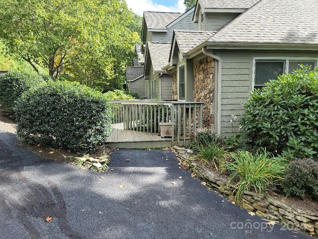 view of property exterior featuring a wooden deck