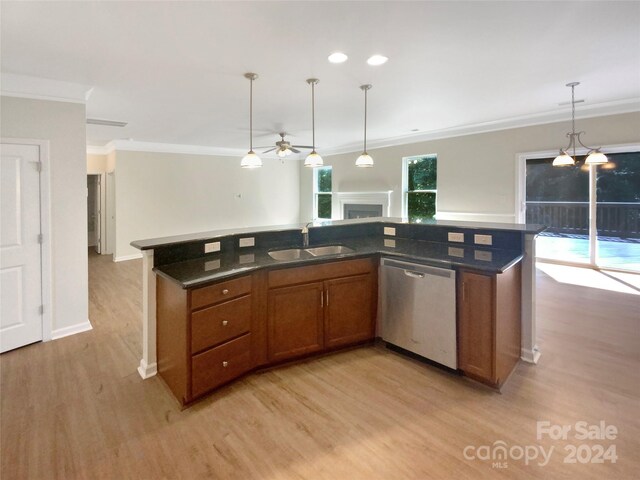 kitchen featuring dishwasher, decorative light fixtures, sink, and light hardwood / wood-style floors