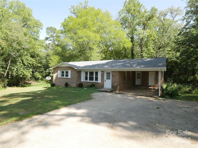 view of front facade with a front lawn and a carport