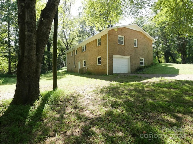 view of home's exterior featuring a yard and a garage