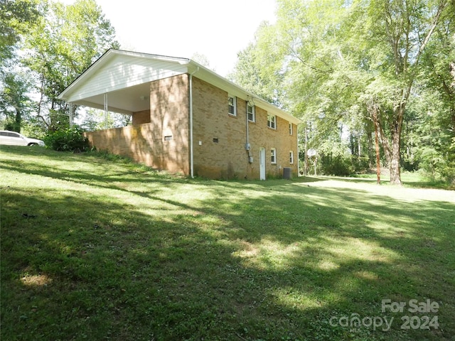 view of side of property with a lawn