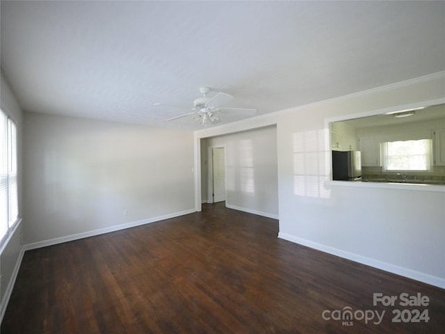 unfurnished room featuring ceiling fan, crown molding, and dark hardwood / wood-style flooring