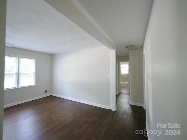 unfurnished room with dark wood-type flooring