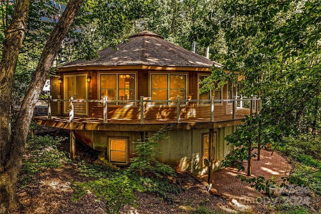 rear view of house featuring a deck