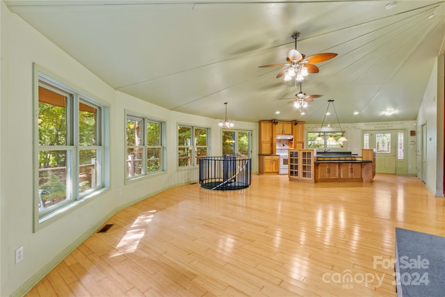 interior space featuring ceiling fan, light hardwood / wood-style floors, and vaulted ceiling