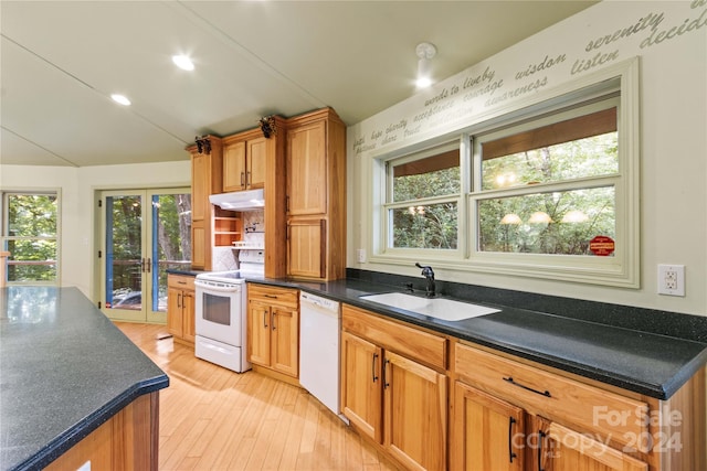 kitchen with white appliances, light hardwood / wood-style floors, and sink