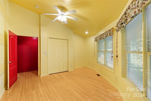 unfurnished room featuring vaulted ceiling, light hardwood / wood-style flooring, and ceiling fan