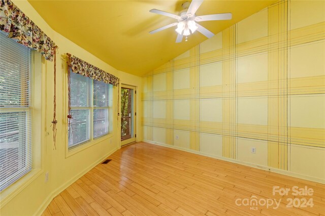 unfurnished sunroom with vaulted ceiling and ceiling fan