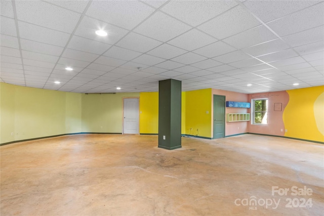 below grade area featuring recessed lighting, baseboards, and a paneled ceiling