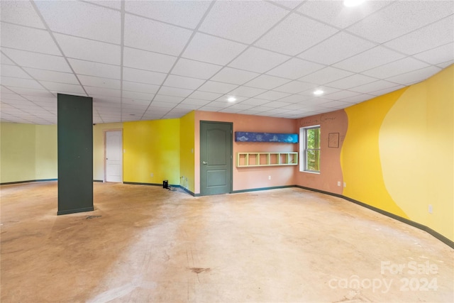 basement featuring recessed lighting, baseboards, and a paneled ceiling