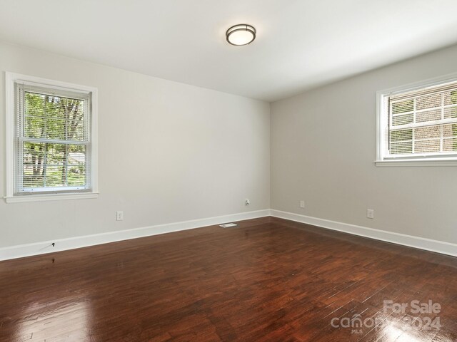 spare room featuring dark hardwood / wood-style flooring