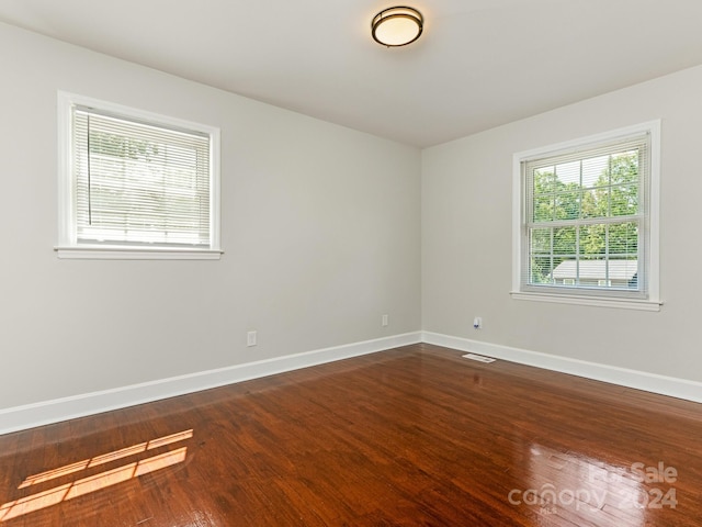 unfurnished room featuring hardwood / wood-style flooring