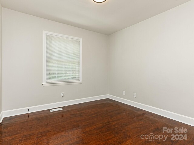 empty room featuring dark hardwood / wood-style floors