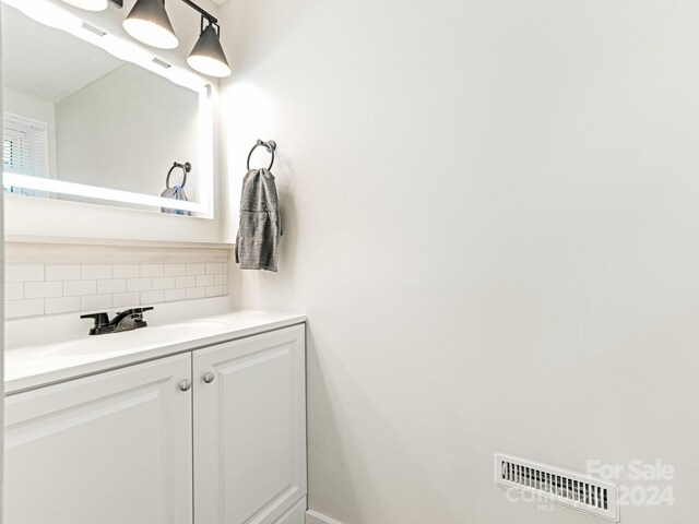 bathroom with backsplash and vanity