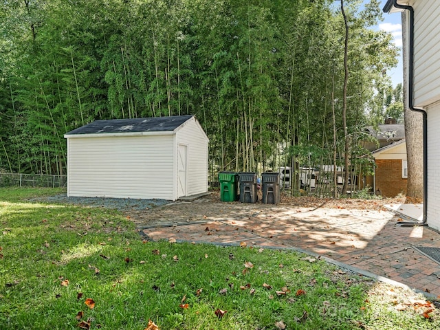 view of yard featuring a patio area and a storage unit