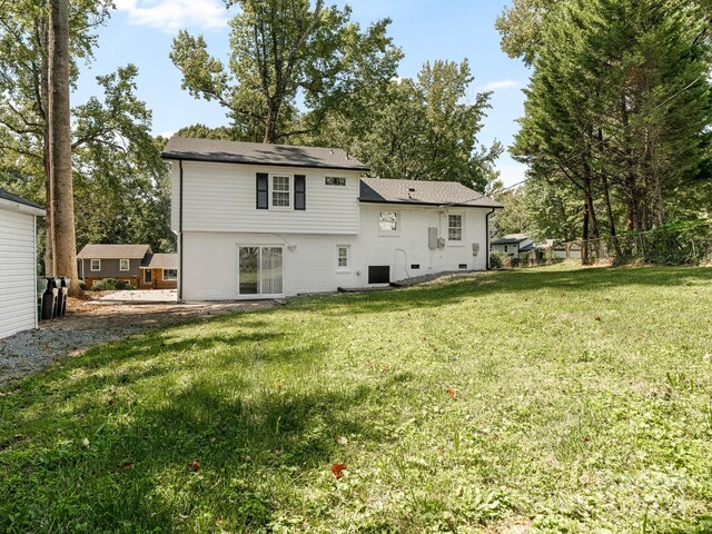 back of property with a lawn and central AC unit