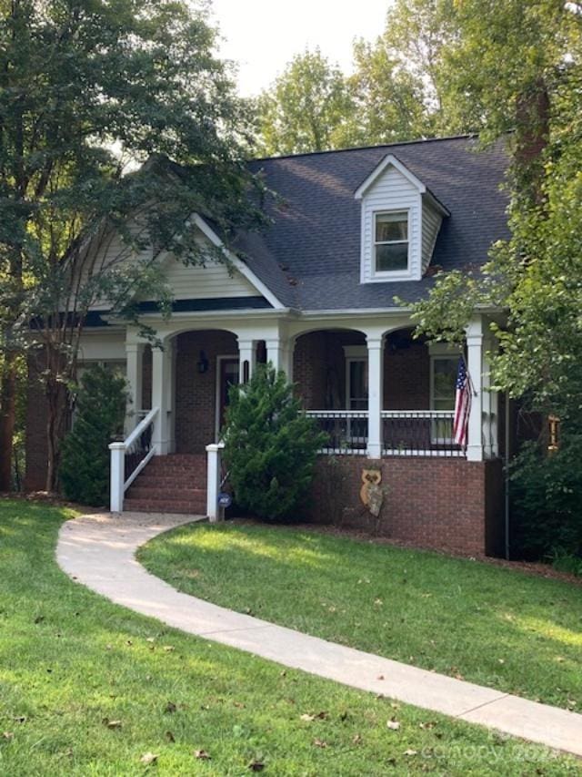 view of front of home featuring a front yard and covered porch