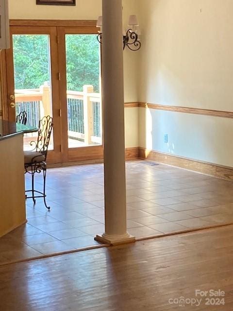 interior space with tile patterned flooring and decorative columns