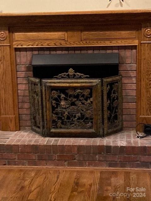 room details featuring hardwood / wood-style flooring and a fireplace