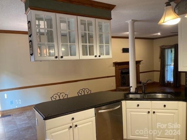 kitchen with ornamental molding, white cabinetry, decorative columns, dishwasher, and sink