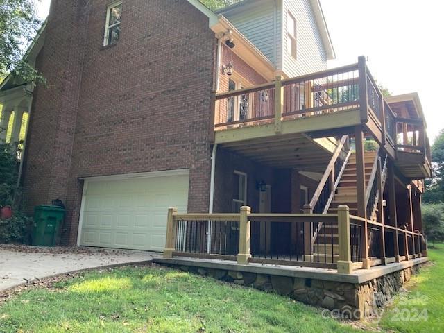 rear view of house with a garage and a deck