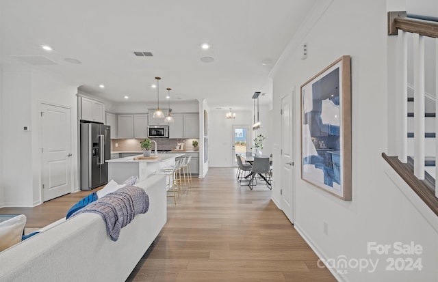 living room featuring ornamental molding and light hardwood / wood-style floors