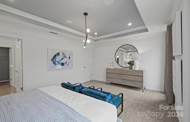 bedroom with a raised ceiling and light colored carpet