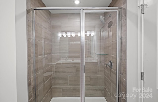 bathroom with a shower with door