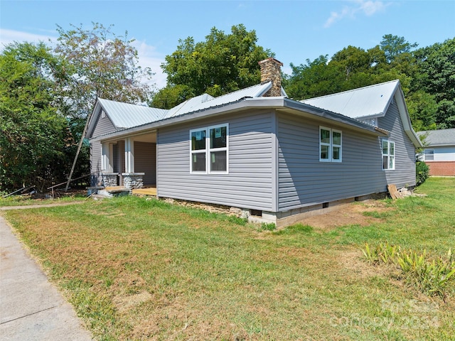 view of side of property with a yard