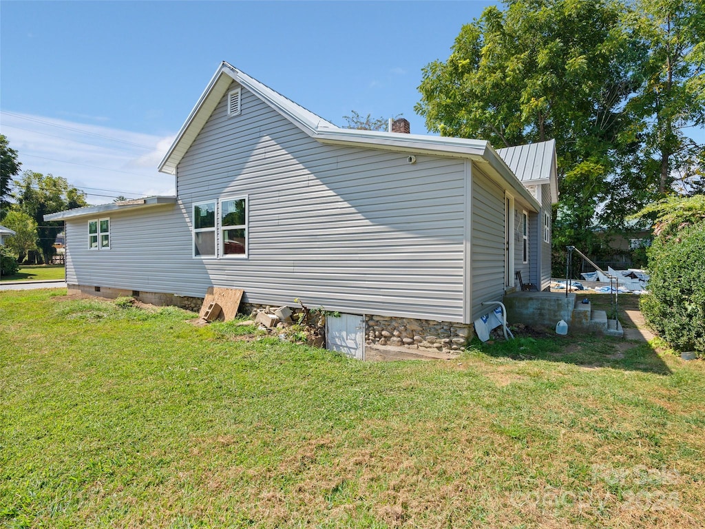 view of property exterior with a lawn