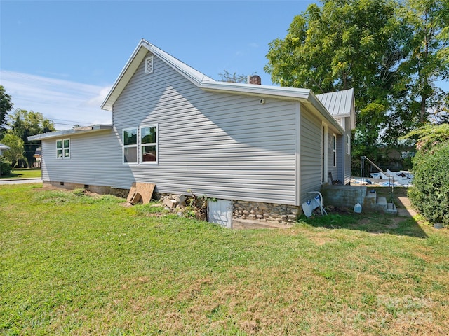 view of property exterior with a lawn