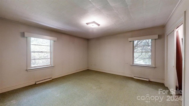 spare room featuring carpet floors and a baseboard radiator