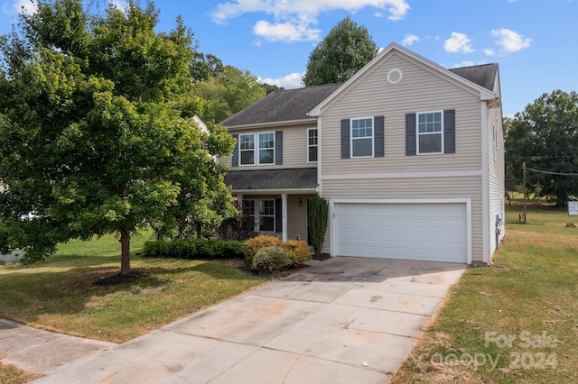 front facade featuring a garage and a front lawn